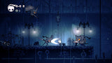 Hollow Knight – skærmbillede med ridder i blåt grottelandskab