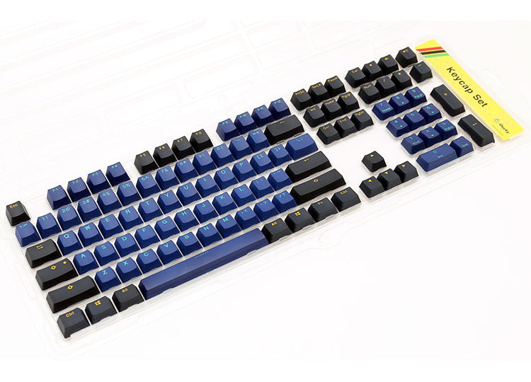 Tastatur med blå, sorte og hvide taster set fra siden